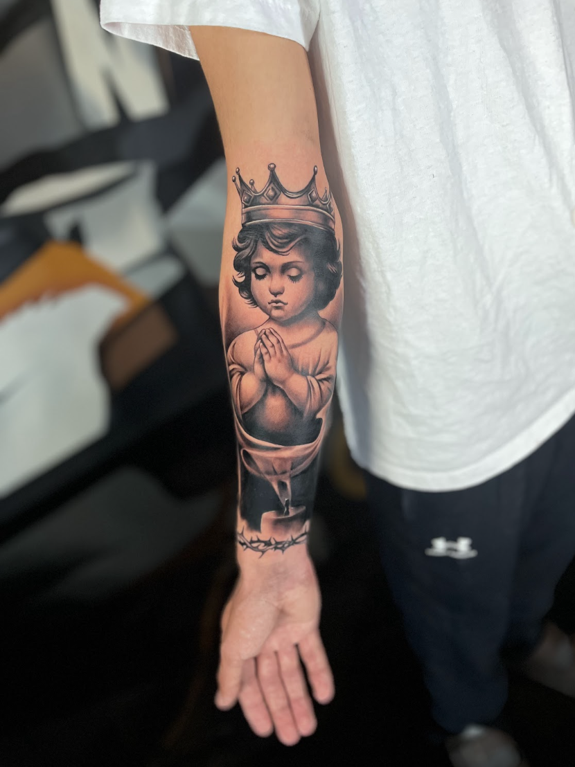 Crowned child praying, black and grey forearm